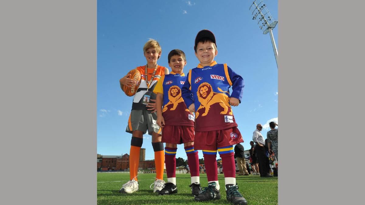 KITTED OUT:Wagga’s Lochie Rosler, 9 and Albury’s Charlie, 6, and Toby Gett, 5, get ready to run on as mascots today.