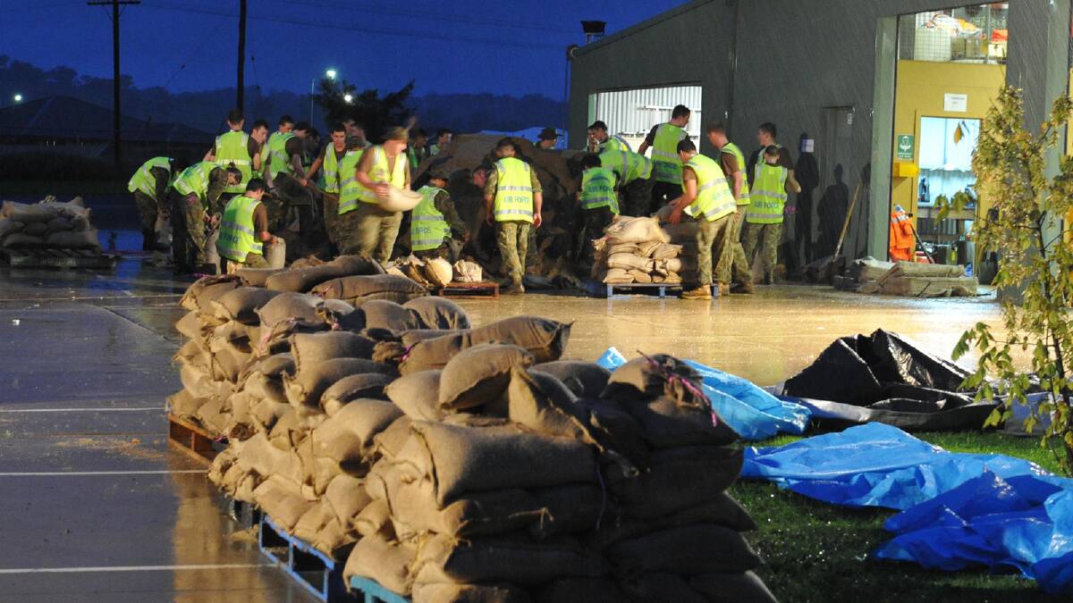 Airforce personnel fill sandbags at SES headquarters. Picture: Michael Frogley