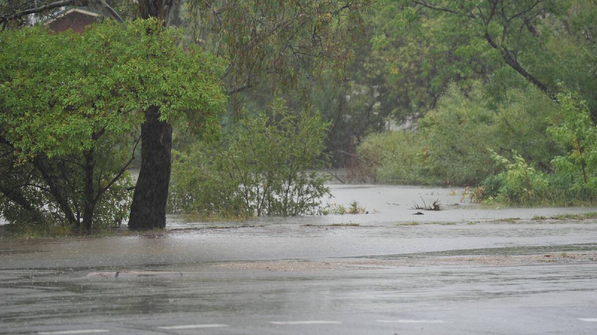 Water from Wollundry Lagoon spills over to flood Ivan Jack Drive. Picture: Oscar Colman