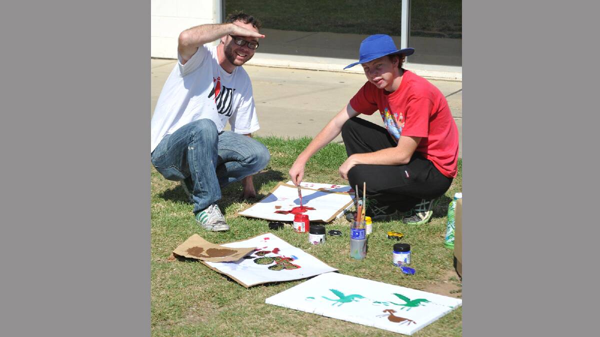 Headspace music festival for Youth Week. Sydney artist Fintan Magee with Jeffrey Ashford, 16, of Wagga making stencils at the art workshop at Bolton Park. Picture: Les Smith