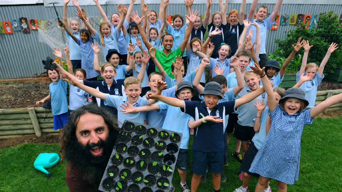 GARDENING GURU: Gardening Australia’s Costa Georgiadis stands with students from Wagga Public School yesterday. Mr Georgiadis will be at Lutheran Primary School’s Sustainable Living Festival from 10am today. Picture: Addison Hamilton