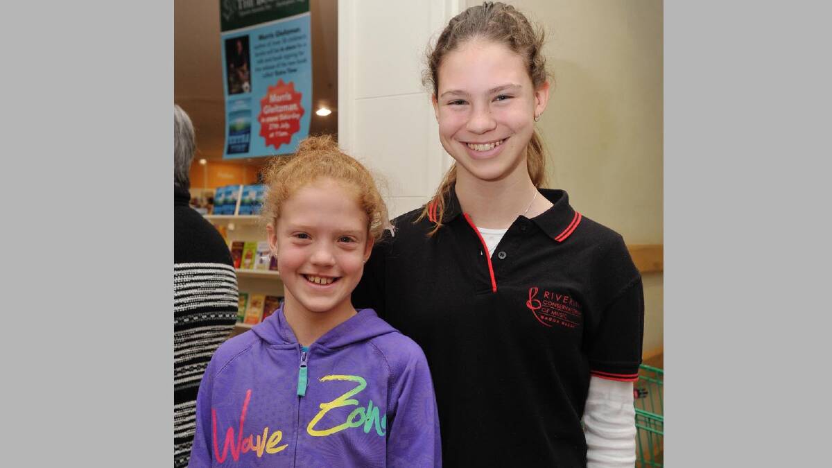 Children's writer Morris Gleitzman visits Wagga to sign his new book Extra Time, along with others. Aine, 10, and Charis Guilfoyle, 14.