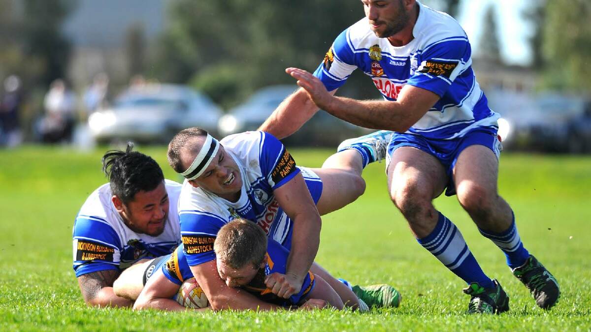 Group Nine Rugby League. Junee vs Cootamundra at Laurie Daley Oval. Junee's Mitch Bradley tackled by Coota's Phil Salue, Luke Berkrey and Rob Tulenew. Picture: Addison Hamilton