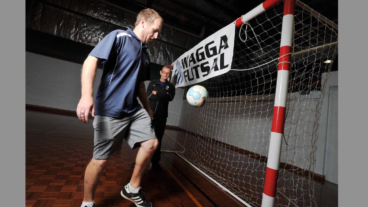 ACTION STATIONS: Gearing up for the start of the Futsal competition in Wagga, Chris Ayton practices ball skills under the watchful eye of Riverina Football coaching and development manager Blaise Fagan at Bolton Park Stadium. 	Picture: Alastair Brook