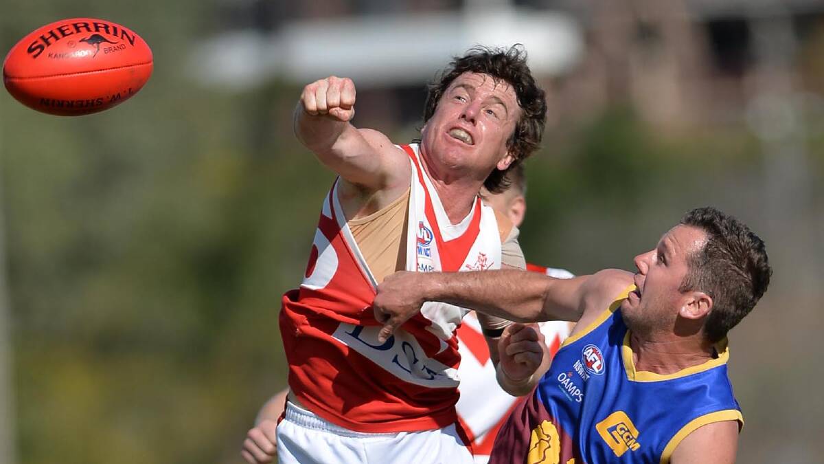 FIERCE CONTEST: Collingullie-Ashmont-Kapooka’s Chris Gow and Ganmain-Grong Grong-Matong coach Jayden Kotzur compete for the ball in yesterday’s preliminary final at Robertson Oval.
