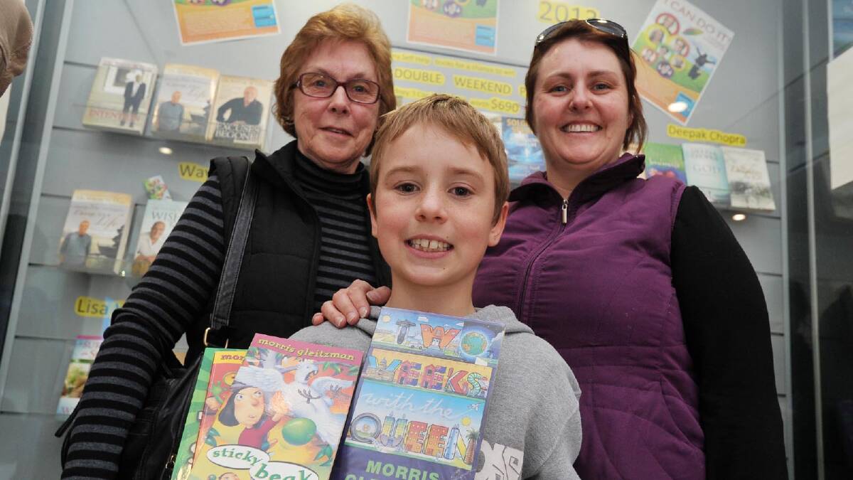 Children's writer Morris Gleitzman visits Wagga to sign his new book Extra Time, along with others. Sue Ryan with William, 9, and Alice King.