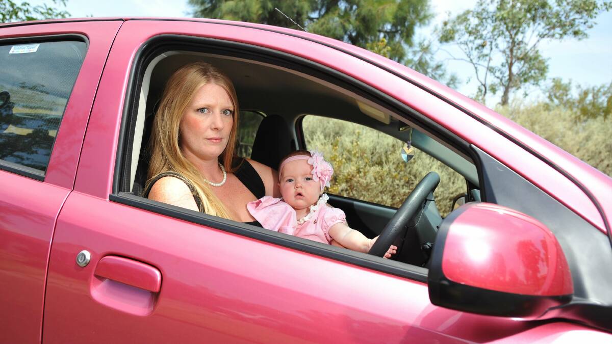 FINED: Katie Finch with baby Rose, now five months' old, in the driveway of their Wagga home. Picture: Alastair Brook
