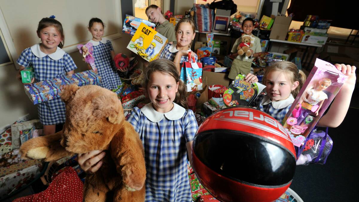 GENEROSITY ABOUNDS: Henschke Primary School students (front) Caitlan Burnett, 9, Jazlynne Lewis, 9, (back from left) Freya Davis, 9, Jessica Woods, 8, Joseph Howe, 8, Josie Carroll, 9 and Ishan Mairata, 9, stand among the pile of donations to go to St Vincent de Paul. Picture: Alastair Brook