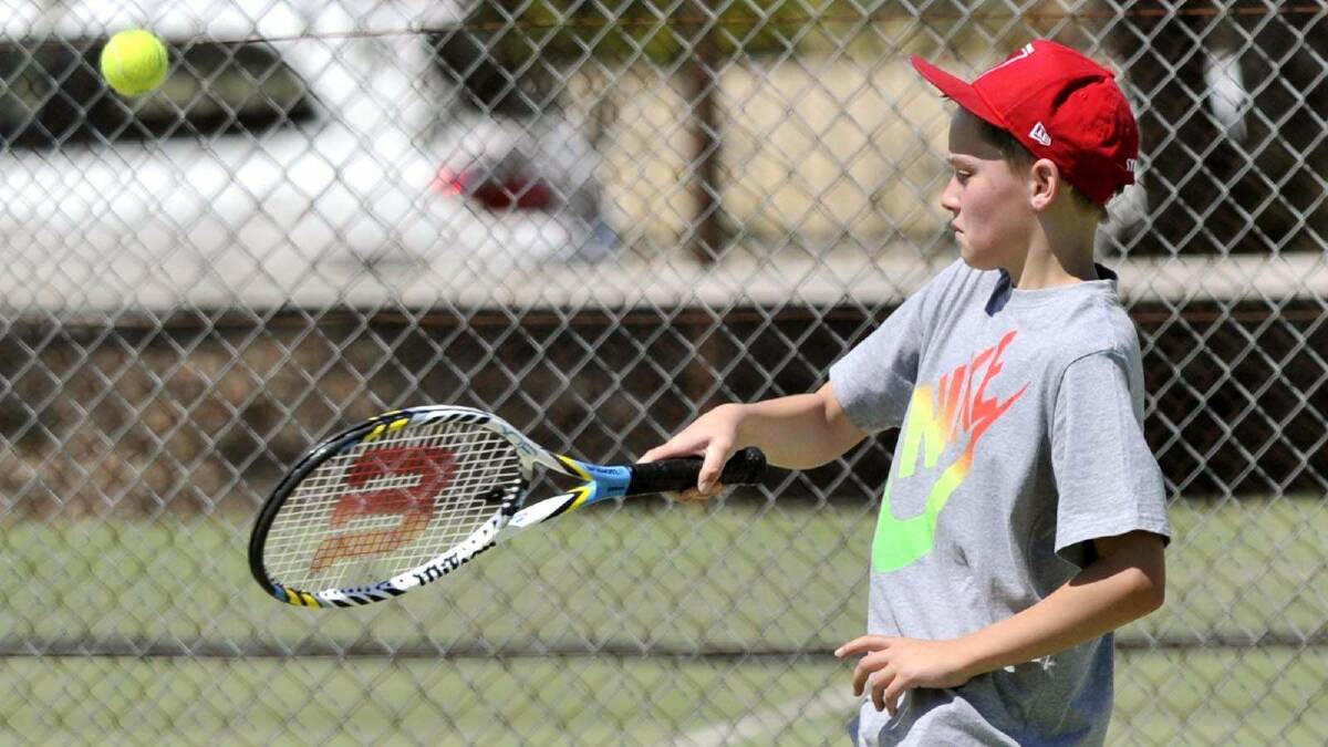 TENNIS: Junior tennis at Bolton Park. Billy Chambers, 11, looks to hit a volley. Picture: Les Smith