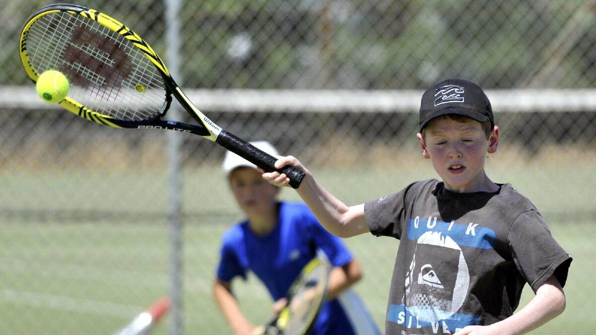 TENNIS: Junior tennis at Bolton Park. Rex Mather, 10, closes his eyes as he makes contact with the ball. Picture: Les Smith