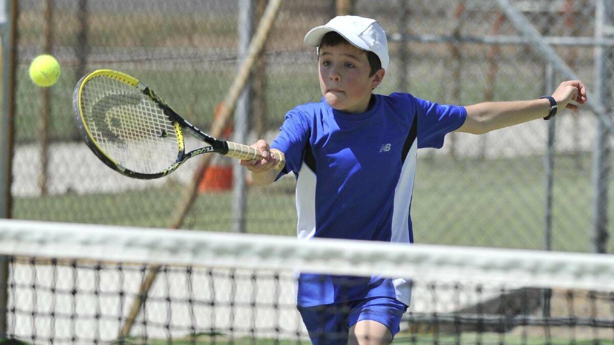 TENNIS: Junior tennis at Bolton Park. Isaac Phyland, 11, makes a volley. Picture: Les Smith
