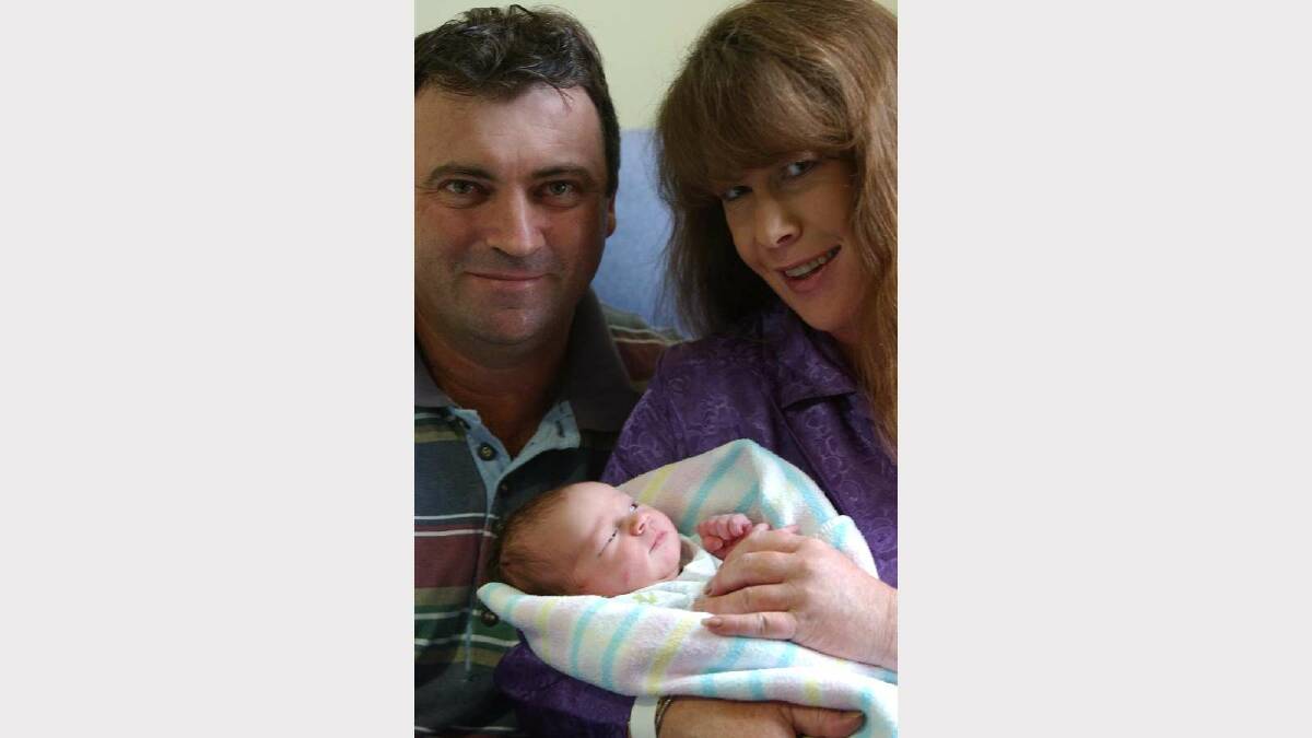 Sophy Ysabella Piper was born at 1.31am on New Year's Day 2002 after a 22-hour labour. Sophy is pictured with parents David and Louise, from Tumut. Picture: Brett Koschel