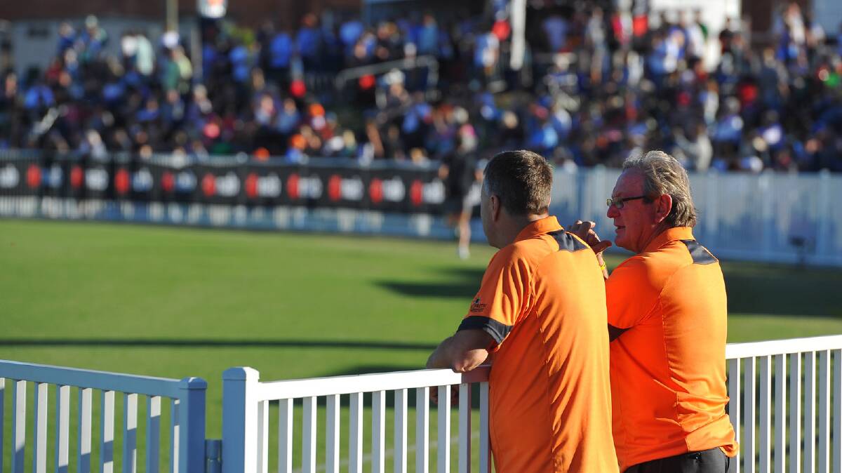 Greater Western Sydney coach Kevin Sheedy chats with his assistant coach as he gazes over the refrubuished surface of Robertson Oval on Saturday. Picture: Addison Hamilton