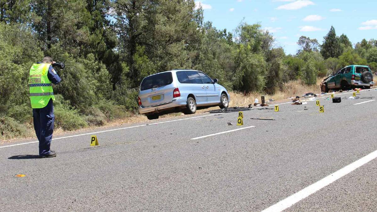 Forensic officers document the crash site where two people died after their Toyota Prado (right) rolled this morning. Six others were injured in the crash. Picture: Bryant Hevesi