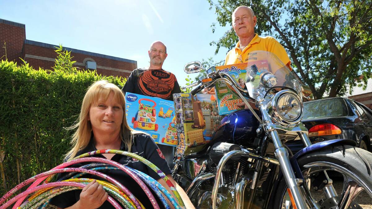 TOYS AT THE READY: Judy Allen, Kerry Anschaw and George Pender are ready for today's Wagga Toy Run. Picture: Michael Frogley 