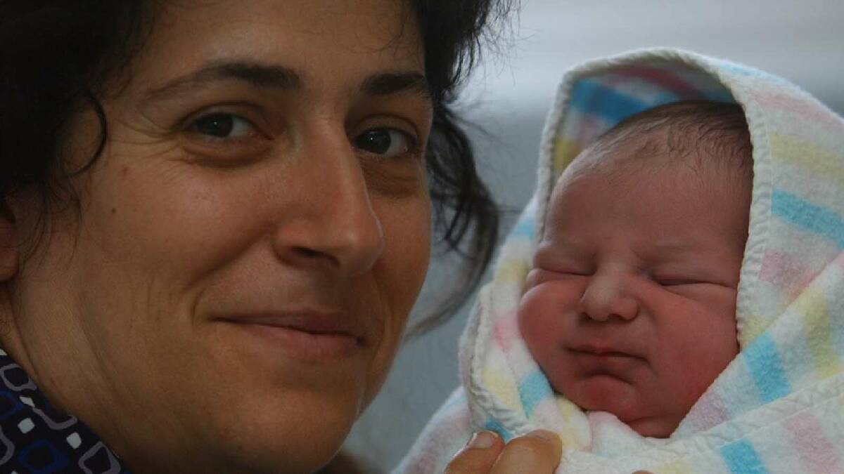 Despite being due to be a Christmas Day 2003 baby, Jaccob Samuel Grasso-Driscoll was born at 11.58am on January 1, 2004 at Wagga Base Hospital. Samuel was the fourth baby for mum Sara Grasso. Jaccob is pictured with midwife Maria Vecchio. Picture: Leanne Santoro