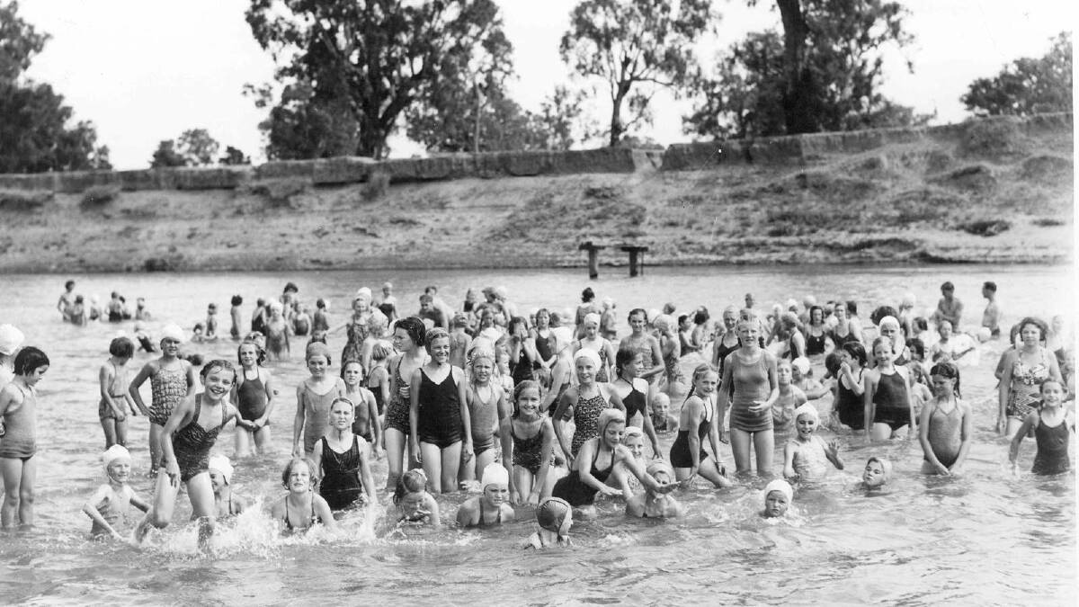 A groupd of children beat the heat at Wagga Beach, circa 1960. Picture: Wagga and District Historical Society