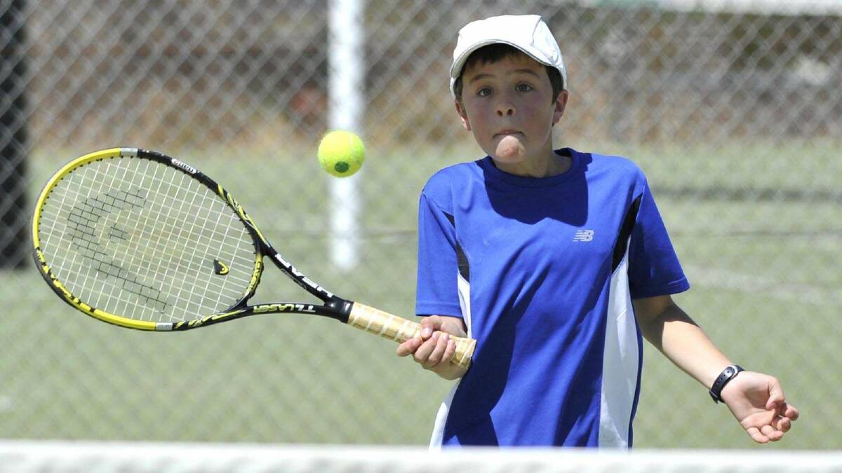 TENNIS: Junior tennis at Bolton Park. Isaac Phyland, 11, makes a volley. Picture: Les Smith