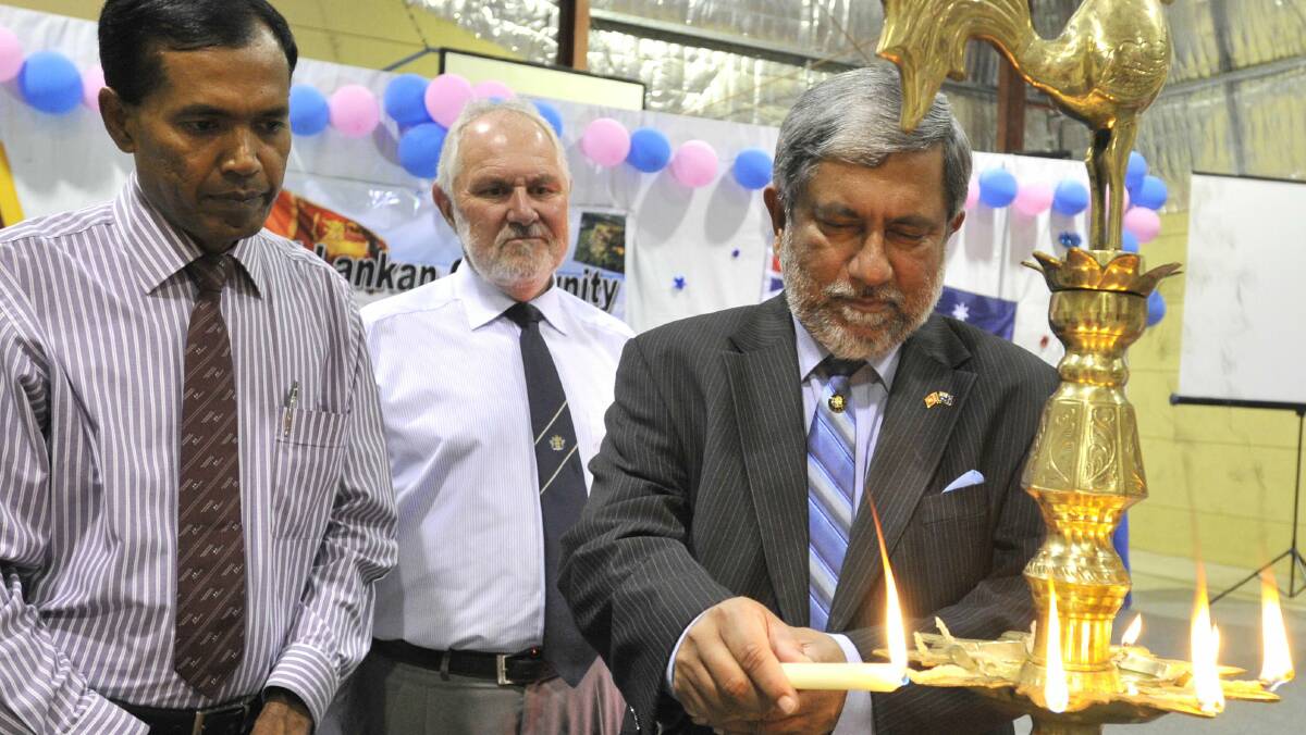 DIPLOMATIC PRESENCE: Sri Lankan High Commissioner to Australia Admiral Thisara Samarasinghe (right) lights an oil lamp with Wagga mayor Rod Kendall and Wagga Sri Lankans’ Culture and Society president Doctor Yapa Bandara. Picture: Les Smith