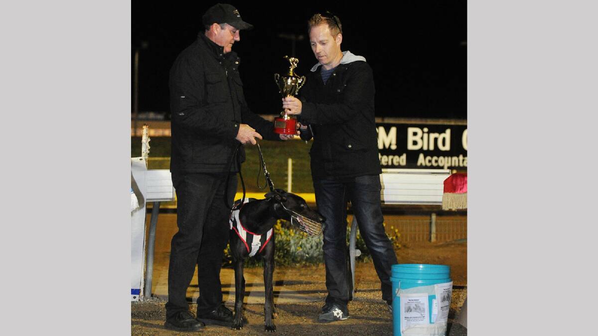 Winning trainer Michael Carter is presented with the Wagga Cup by Brett Hull. Picture: Alastair Brook