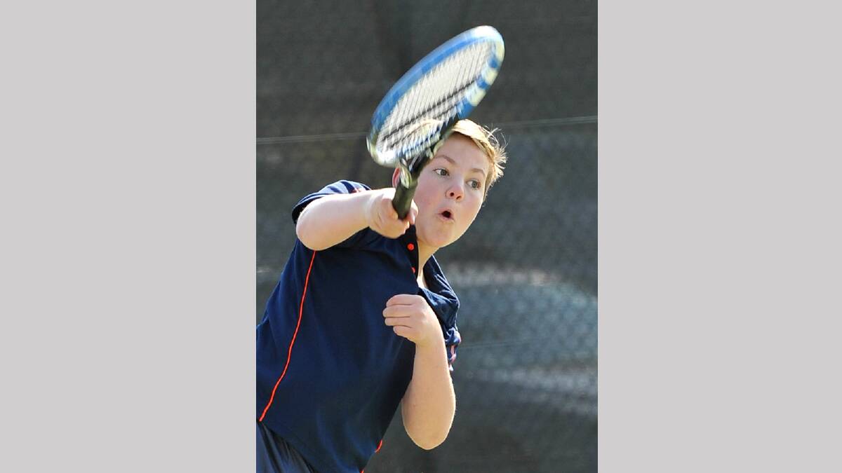 Ben Schirmer, 13, hits a serve in junior tennis. Picture: Michael Frogley 