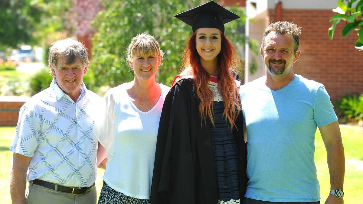Bill Burkinshaw, Chris Warner and Perry Warner congratulate Kirsty Warner on her Bachelor of Arts degree. Picture: Addison Hamilton