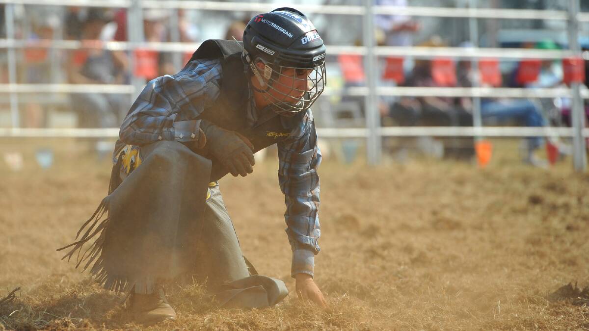 Jake Curtis hits the dirt in the under 18s bull riding competition at the Coolamon Rodeo. Picture: Addison Hamilton