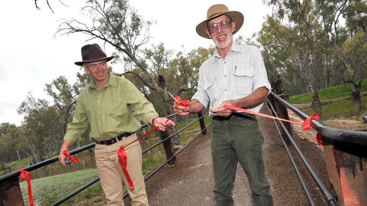 Project managers Peter Beal and Terry Smith cut the ribbon to open the Rocky Waterholes Bridge as part of Narrandera's sesquicentenary celebrations. Picture: Les Smith