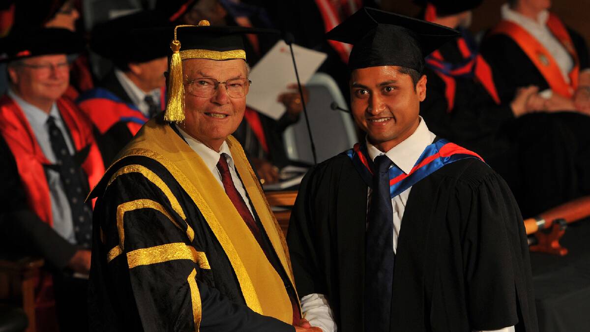 Rinaldo D'Souza receives a Masters of Networking and System Administration from CSU chancellor Lawrence Willett. Picture: Addison Hamilton