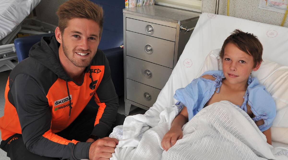Clayton Jones, 12, of Uranquinty with GWS player Callan Ward at the Wagga Base Hospital. Picture: Michael Frogley