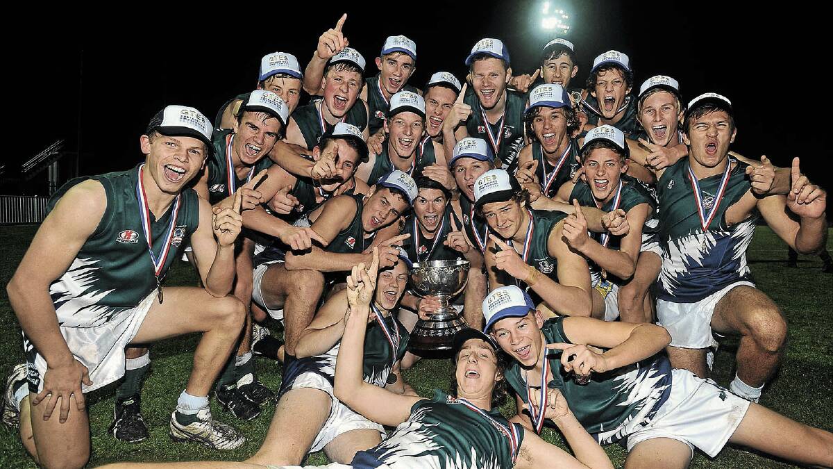 HISTORY IN THE MAKING: The TRAC team celebrates winning its first Carroll Cup last night, beating Mater Dei by nine points at Robertson Oval in front of a big crowd. Picture: Addison Hamilton