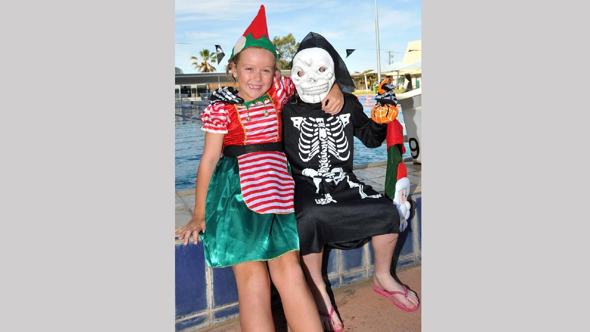 Having a laugh at the Wagga Swimming Club Christmas Party at the Oasis are Abbey Senior, 7, and Natalia Horsley, 7. Picture: Michael Frogley
