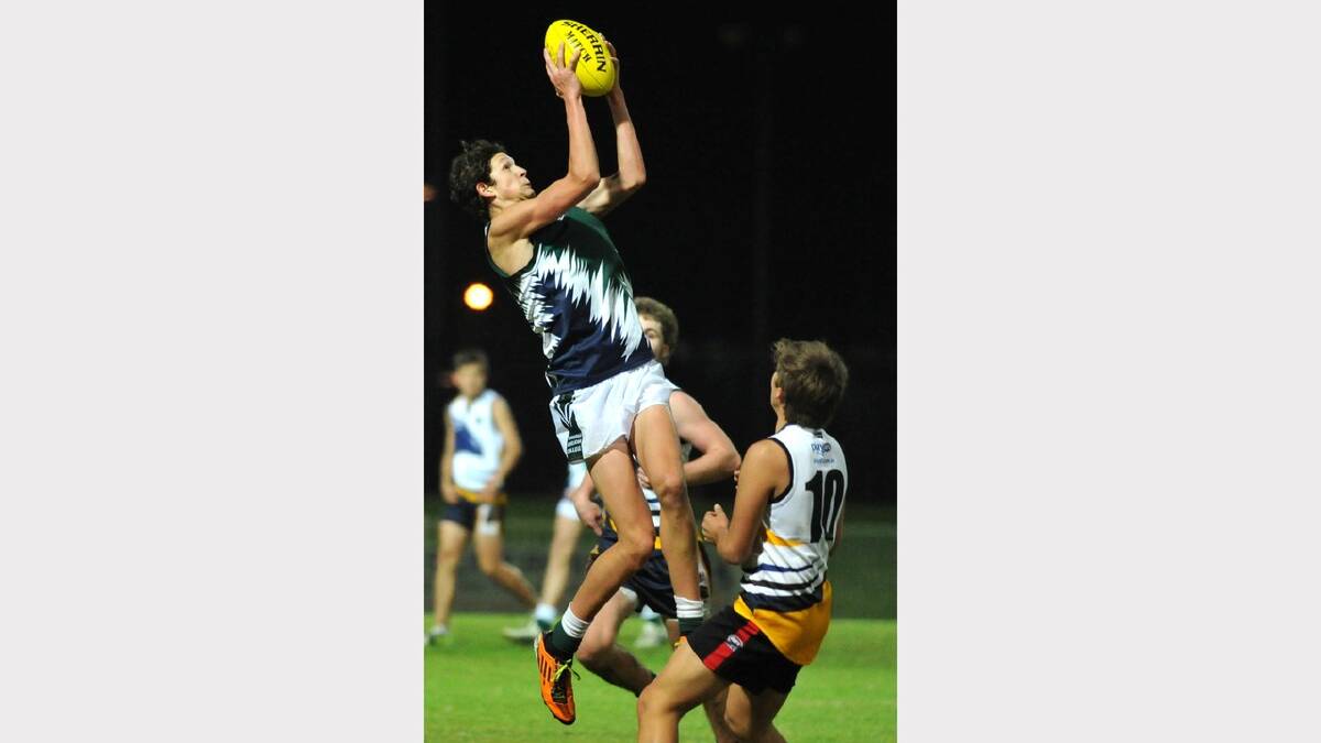 TRAC's Jake Gunning leaps high to take a mark. Picture: Les Smith