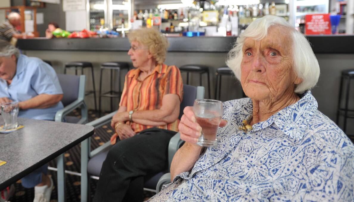 COOL RELIEF (below): Barbara Organ enjoys a cool drink at the Tarcutta RSL Club. Picture: Oscar Colman