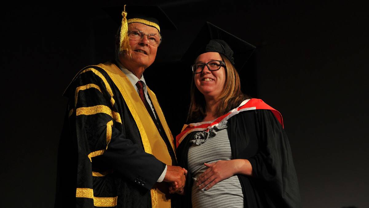 Chancellor of CSU Lawrence Willett congratulating Shona Pratt on her Bachelor of Arts (Photography). Picture: Addison Hamilton 