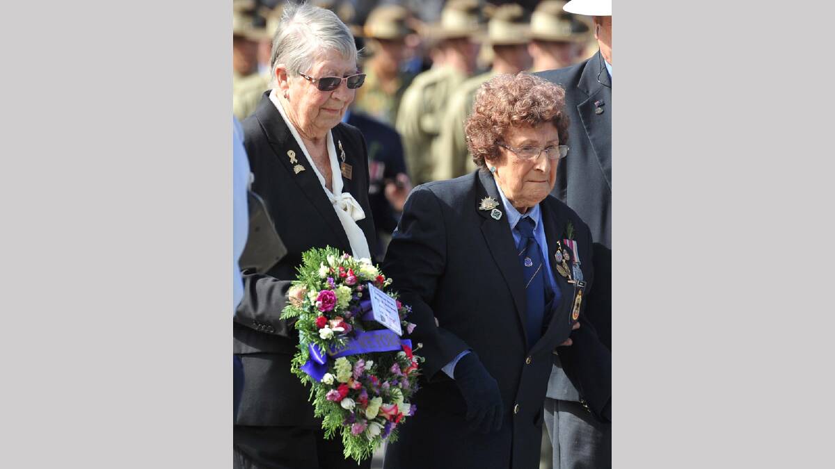 Ex-Servicewomen Alice Lucas and May Bruce laying wreaths in the Anzac Day march in Wagga. Picture: Michael Frogley