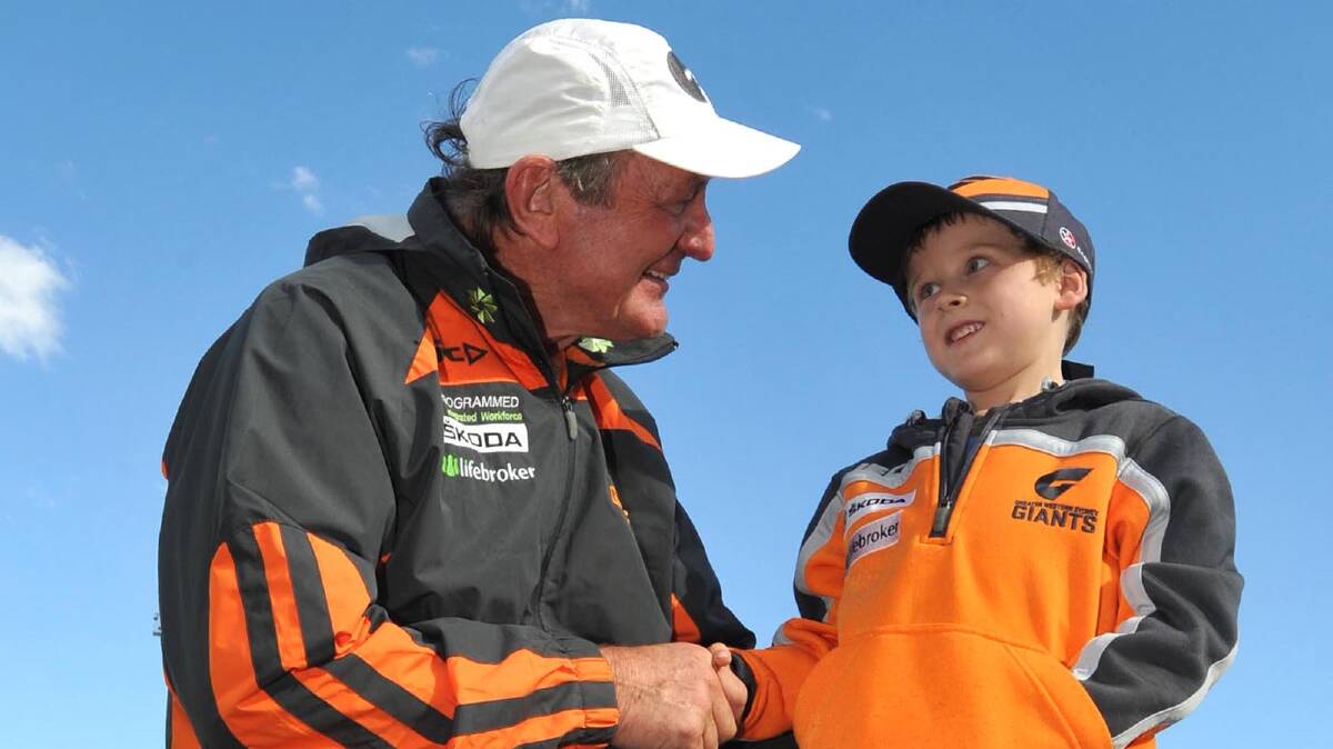 GWS fan Ben Halloran, 6, of Wagga, meets with Giants coach Kevin Sheedy. Picture: Les Smith