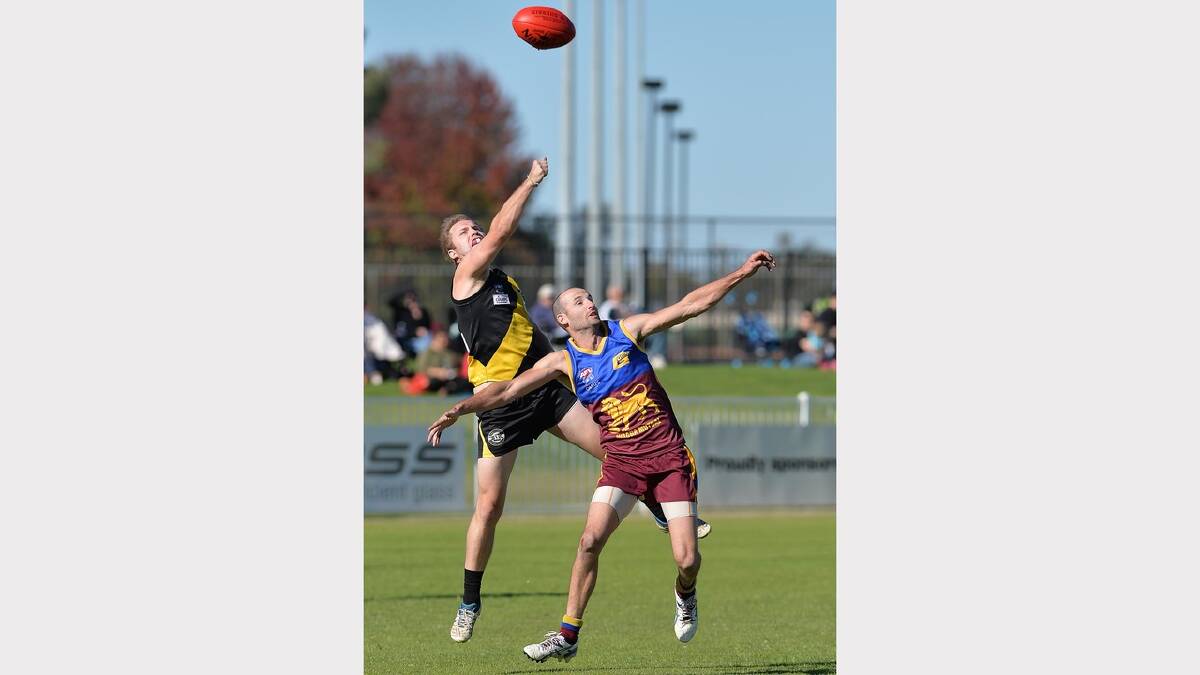 Patrick Noonan (left) thumps the ball away above Mitchell Steele. Picture: Michael Frogley