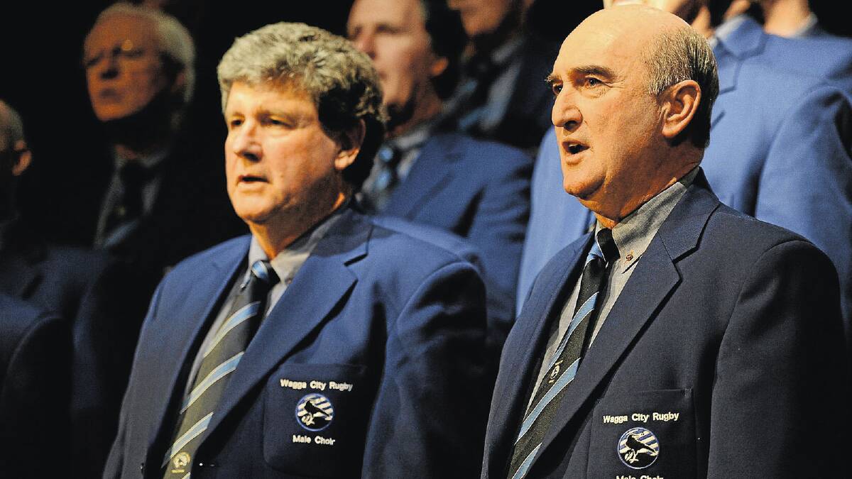 SING IT: Fierce clubman Dave Mundy (left) heads the Wagga City Rugby Mens Choir with John Ferguson in a performance at Kooringal High School last year. Mundy has penned an adaptation of a classic Banjo Patterson poem that has fuelled the rivalry between Wagga City and Waratahs before Saturday’s SIRU semi-final.
