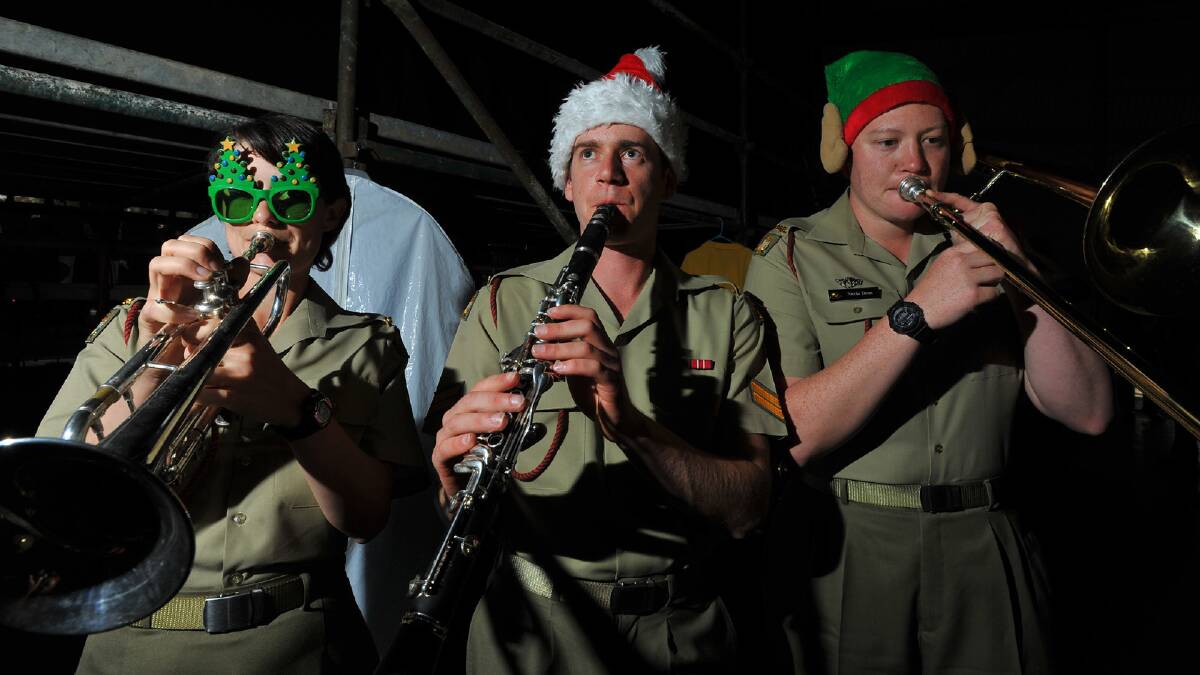 (From left) Acacia Cuthbertson, Nathan Tillman and Nicola Dunn of the Australian Army Band Kapooka practise shortly put on a festive performance at the Wagga Music Bowl. Picture: Addison Hamilton