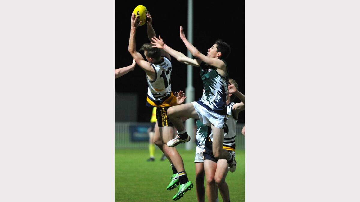 Kooringal High School's Connor Galvin takes a mark in front of TRAC's Riley McMullen. Picture: Les Smith