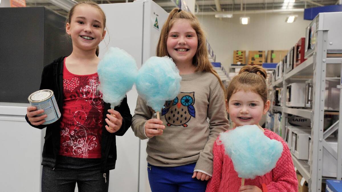 Taylah Whitecross, Tahlia, 9, and Isabella, 4, Koschel tuck into some fairy floss at Masters. Picture: Alastair Brook