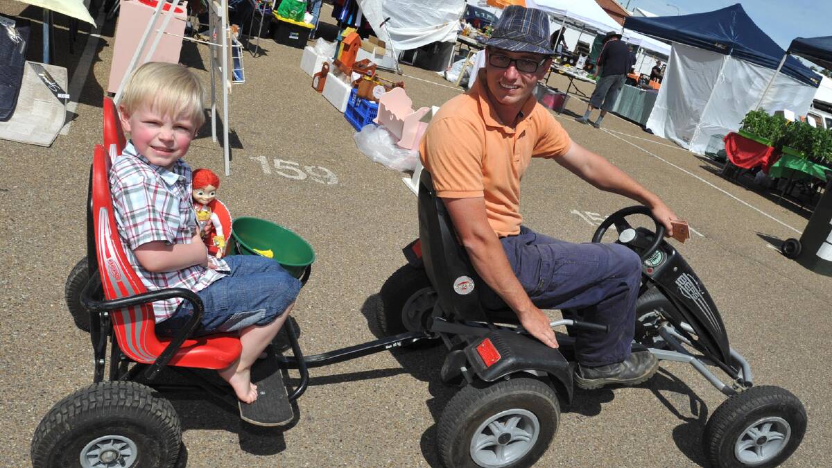 4-year-old Oliver McCabe of Wagga with his dad Andrew handing out popcorn at the Sunday Markets. Picture: Les Smith