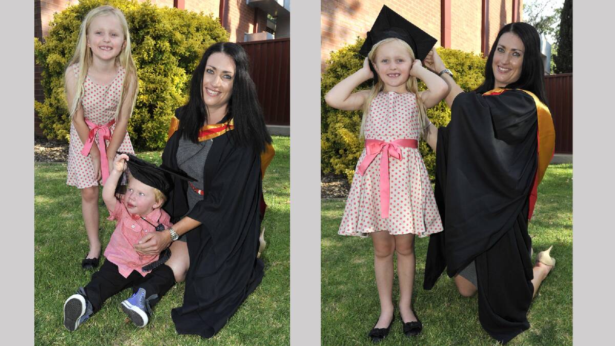 Nursing graduate Lisa Drury's children Isla, 6, and 17-month-old Mannix try out mum's cap for size. Picture: Les Smith