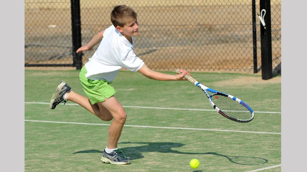 Ben Coe, 11, can't get to the ball in time to hit his shot in junior tennis. Picture: Michael Frogley 