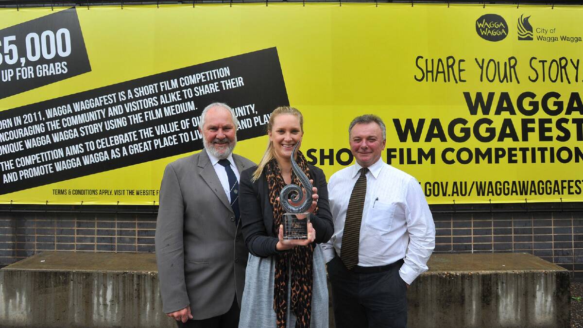 Wagga mayor Rod Kendall (left), joins council’s graphic designer, Sally Marceau, and manager of executive services, Luke Grealy, to celebrate the award-winning Wagga WaggaFest short film competition. Picture: Addison Hamilton