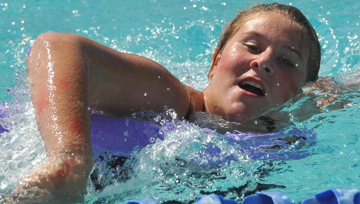 Kelli Cotter, 16, in the novelty event at the Mount Austin swimming carnival. Picture: Les Smith