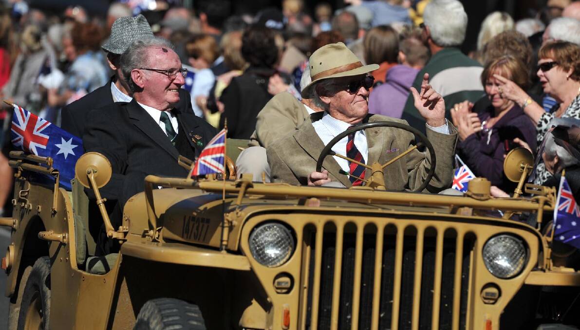 Veterans Tony Edmunds (driving), Bob Menzies (front seat passenger) and rear passengers Ben Newbery and Keith Spokes in the Anzac Day march at Wagga. Picture: Michael Frogley