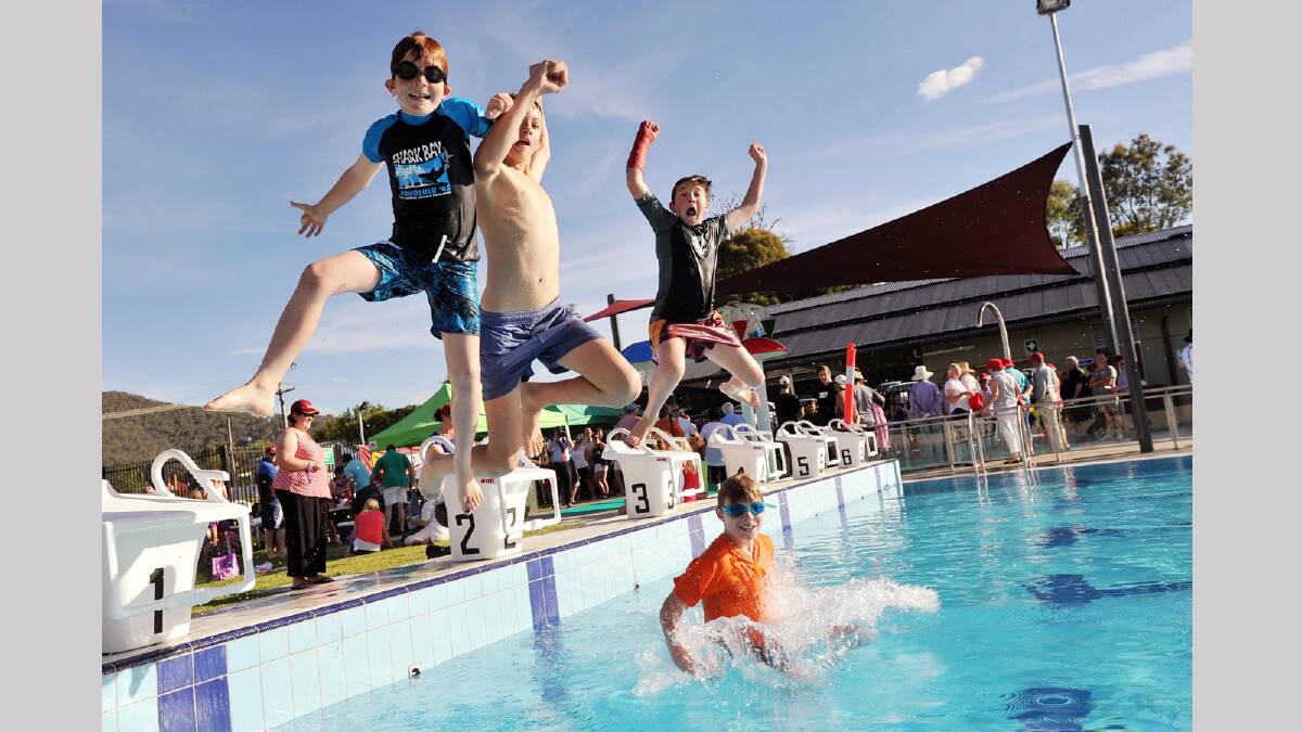 Tyson Whiting, 8, Connor McLennan, 12, Corey Wilson, 12, and Cooper Dowell, 12, take the plunge into Adelong's new community pool. Picture: Alastair Brook
