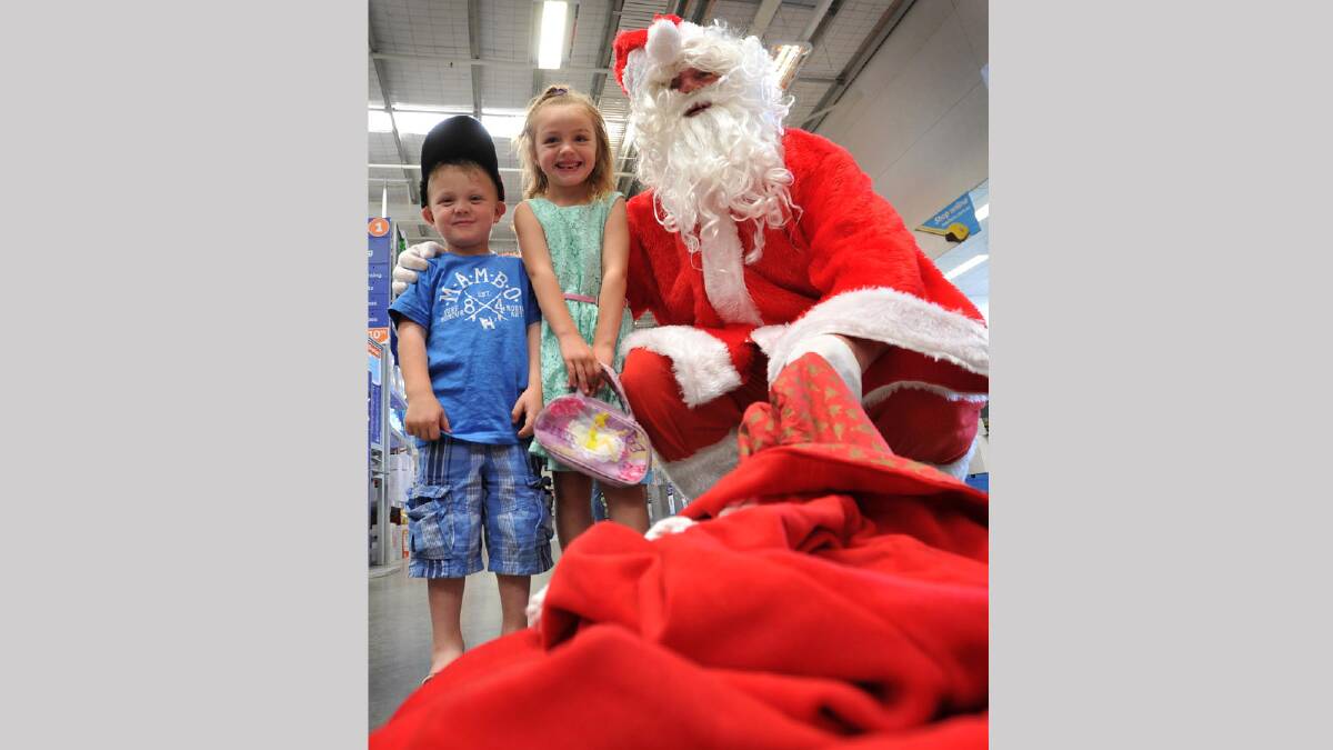 Blake Pendrick, 4, and Izabell Pendrick, 5, of Humula catch up with Santa at Masters. Picture: Alastair Brook